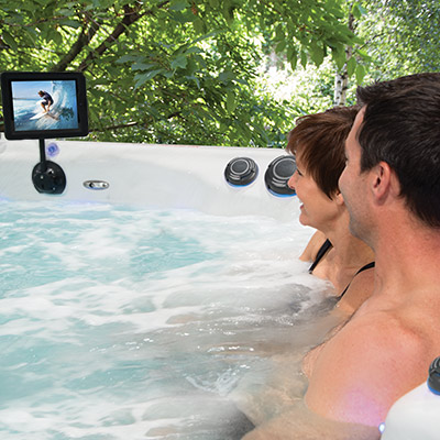 A Couple enjoying their iPod 'Cinema' in their H2X Swim Spa